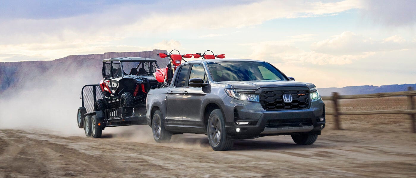 2025 Honda Ridgeline towing an ATV