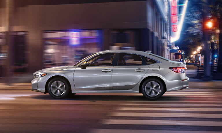 2026 Honda Civic Sedan on city street at night