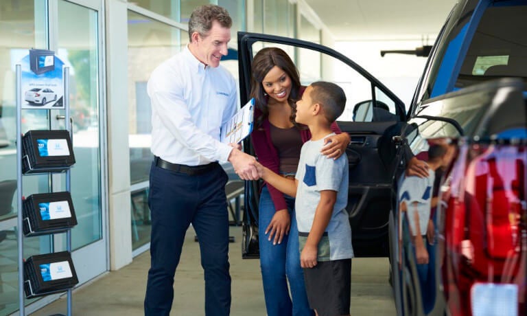 Mother and son making deal on a car