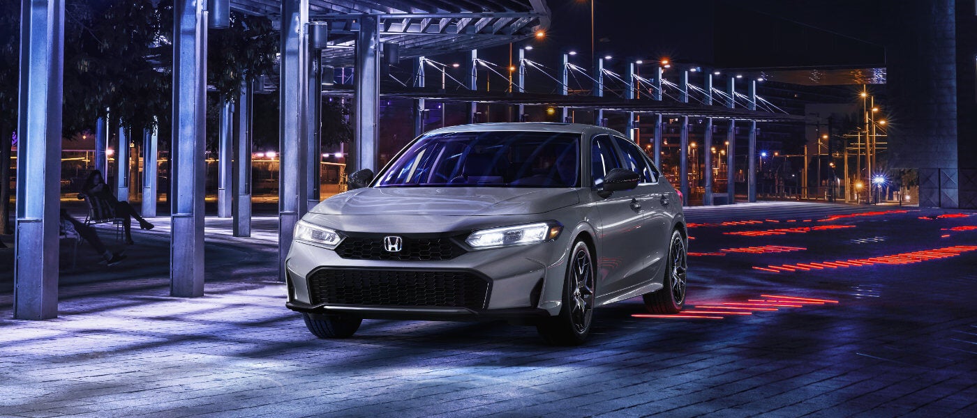 2025 Honda Civic parked under a lit promenade